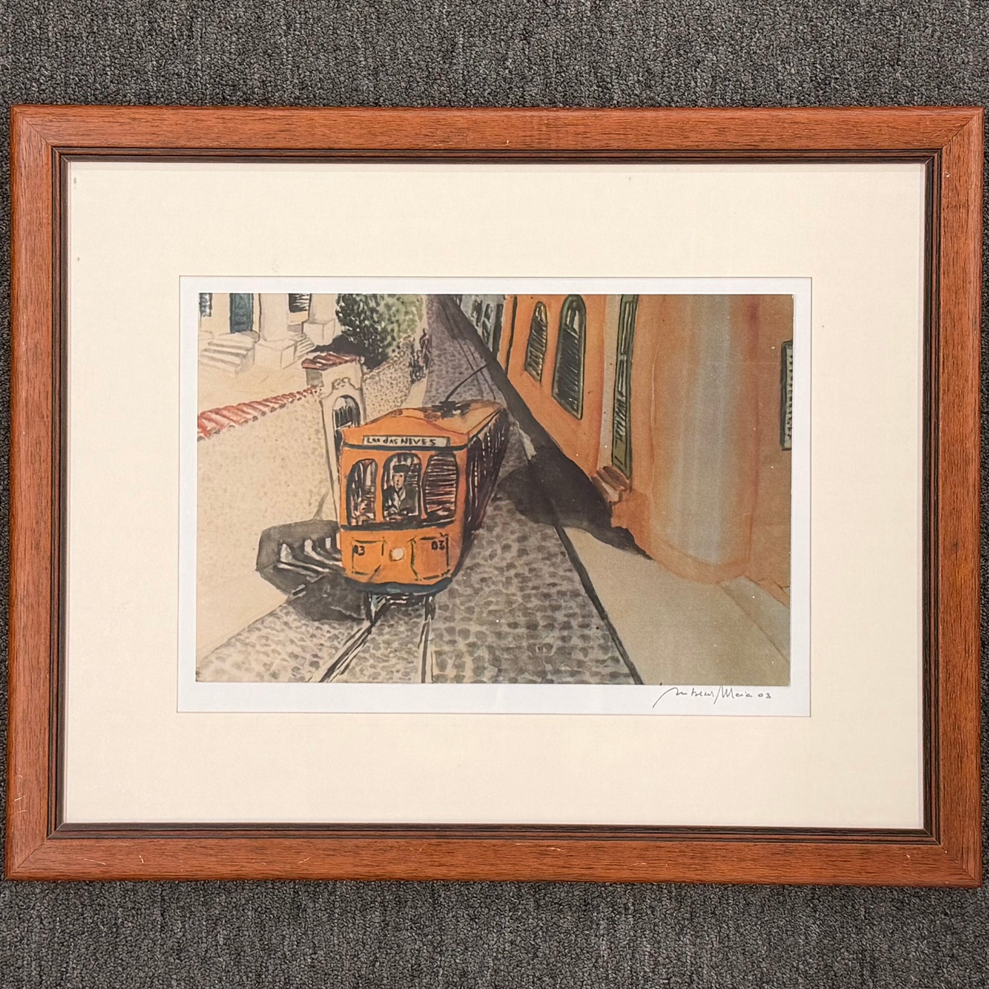 Framed artwork of a train on tracks with a building in the background