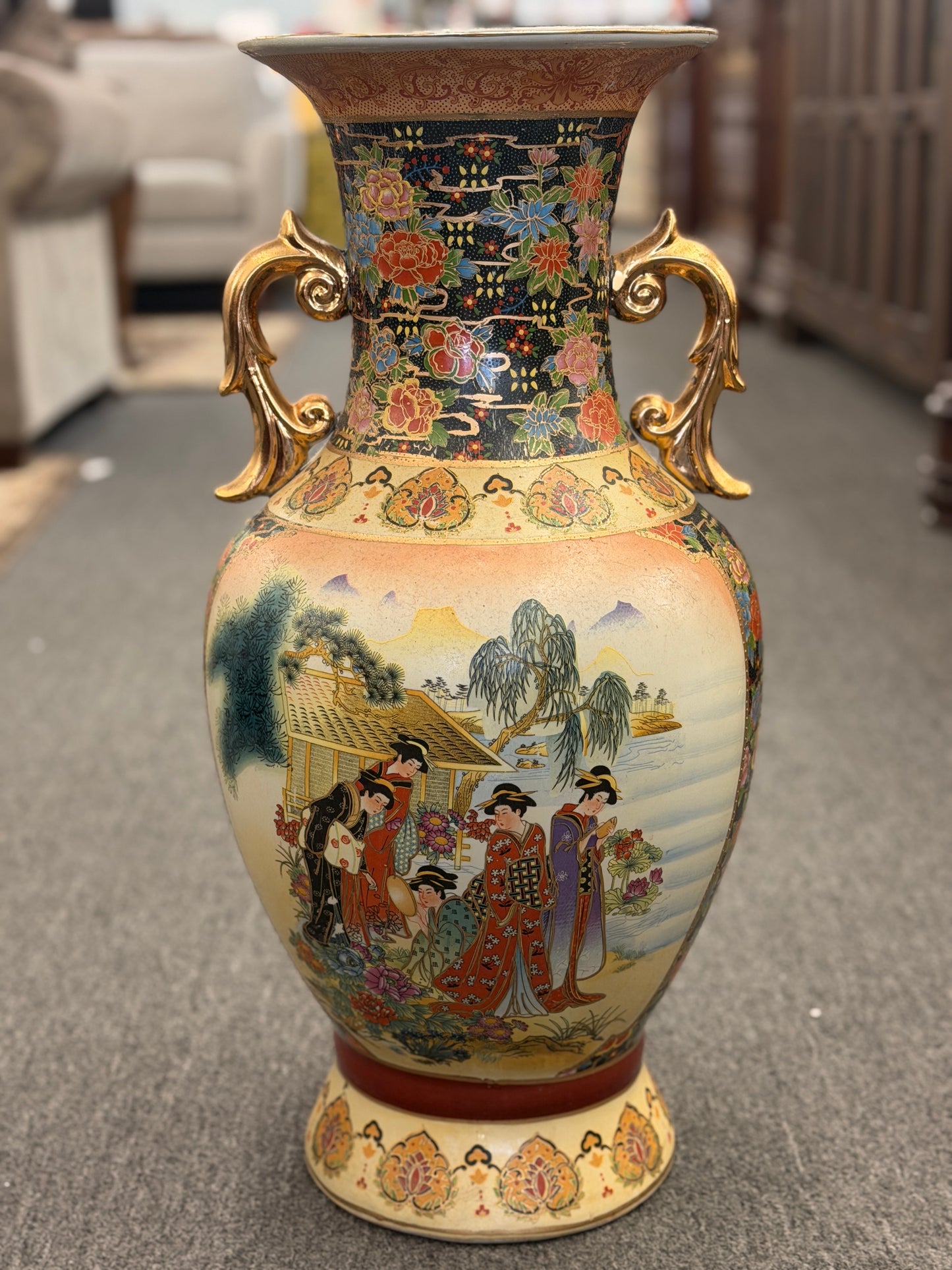 Decorative vase with intricate designs on a carpeted floor