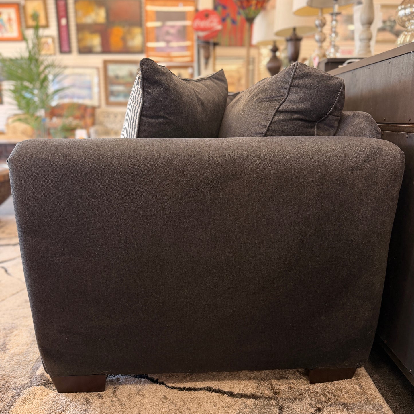 Gray sofa with cushions in a living room setting