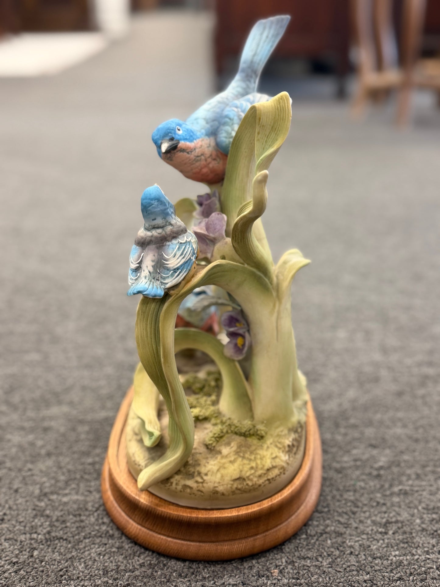 Decorative figurine of birds on a branch with a wooden base