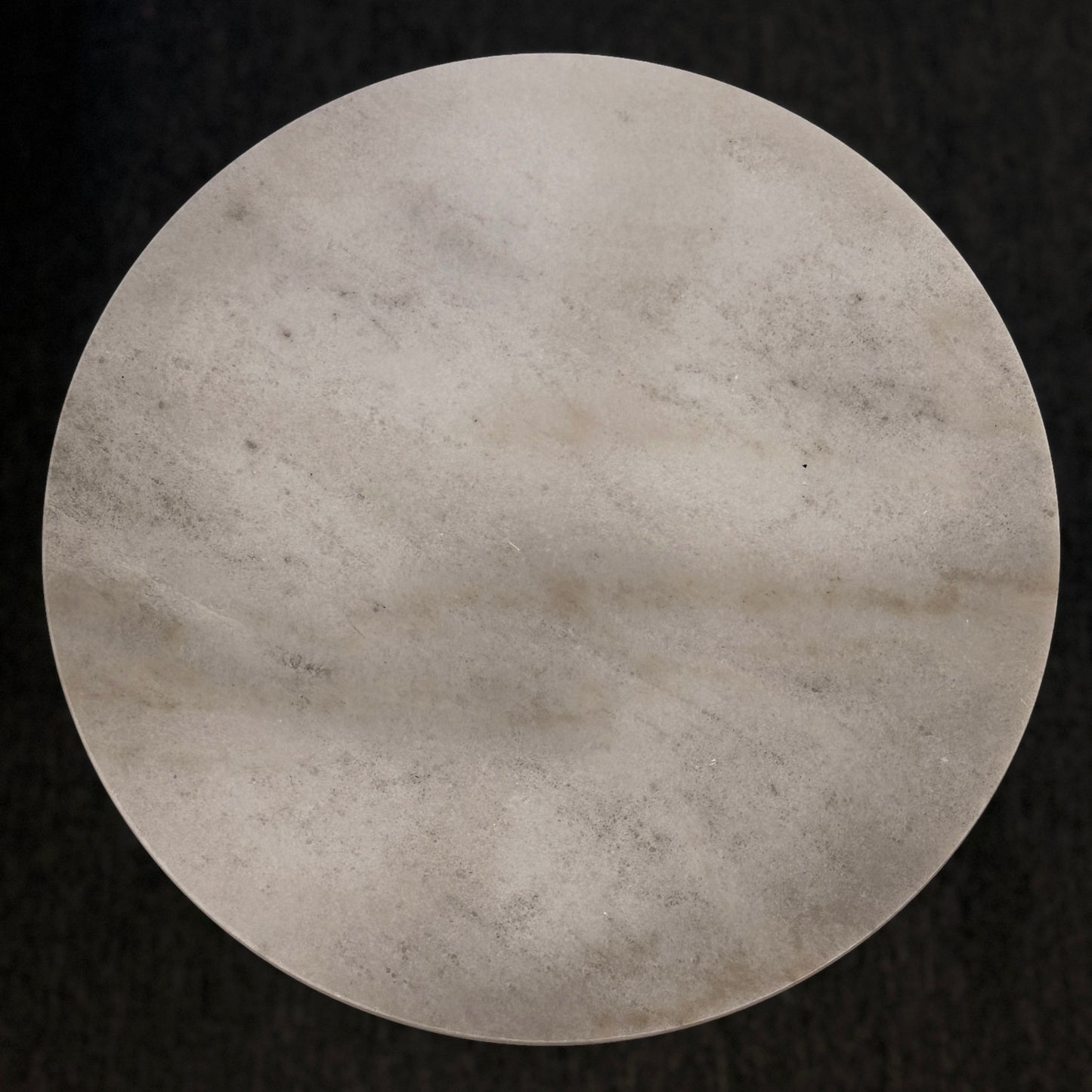 Round stone surface on a black background