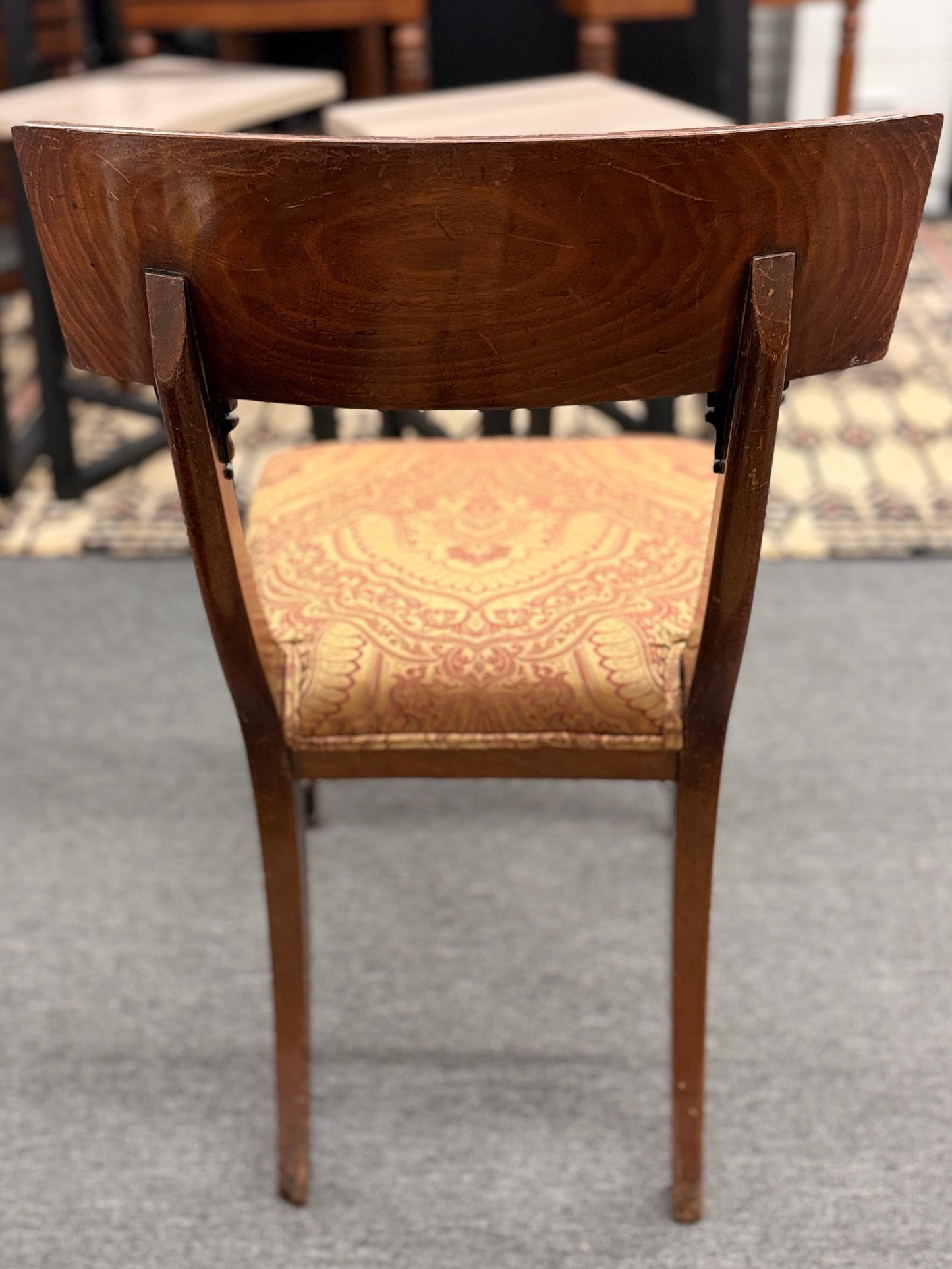Traditional dark wood round pedestal dining set with 51 inch table and patterned fabric chairs at 2nd Debut Houston consignment showroom