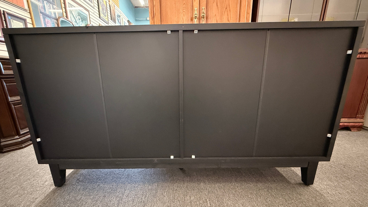 A modern 4-door credenza sideboard with an intricate, carved geometric design featuring concentric diamond and arched wave patterns across the door fronts.