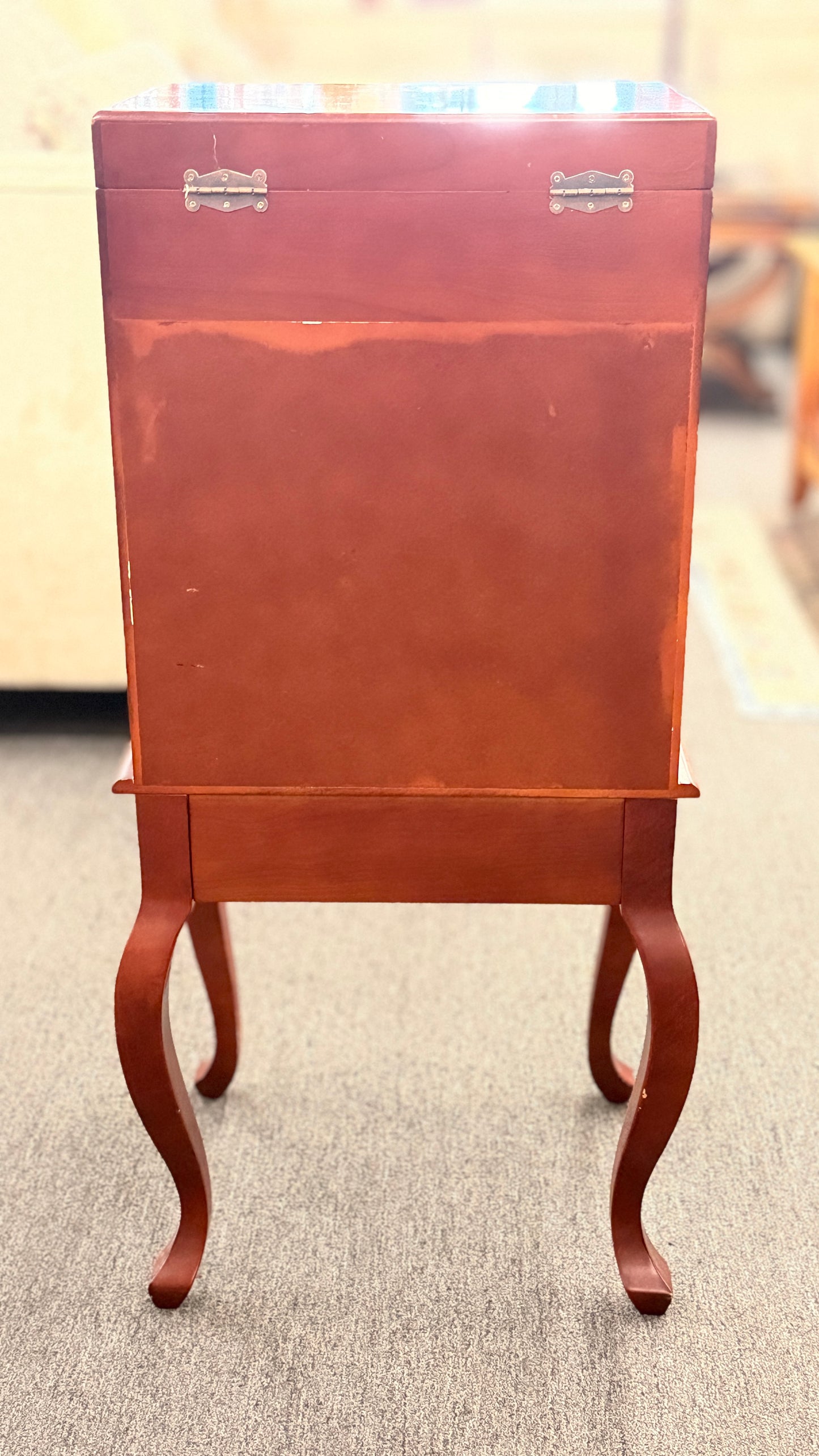 A tall, upright wooden jewelry or silverware chest shown open, revealing a ring-roll top compartment, five stacked drawers, burgundy fabric lining, and metal pulls.
