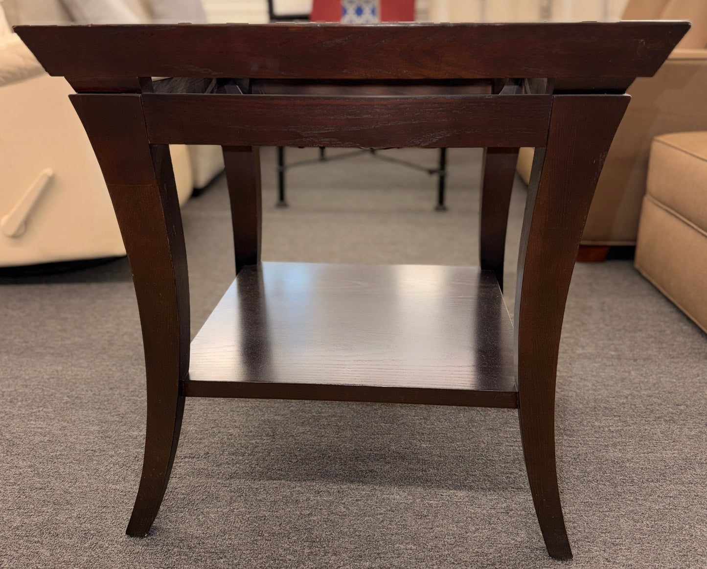 Square dark wood end table featuring a glass top with an intricate woven metal inlay and a lower display shelf.