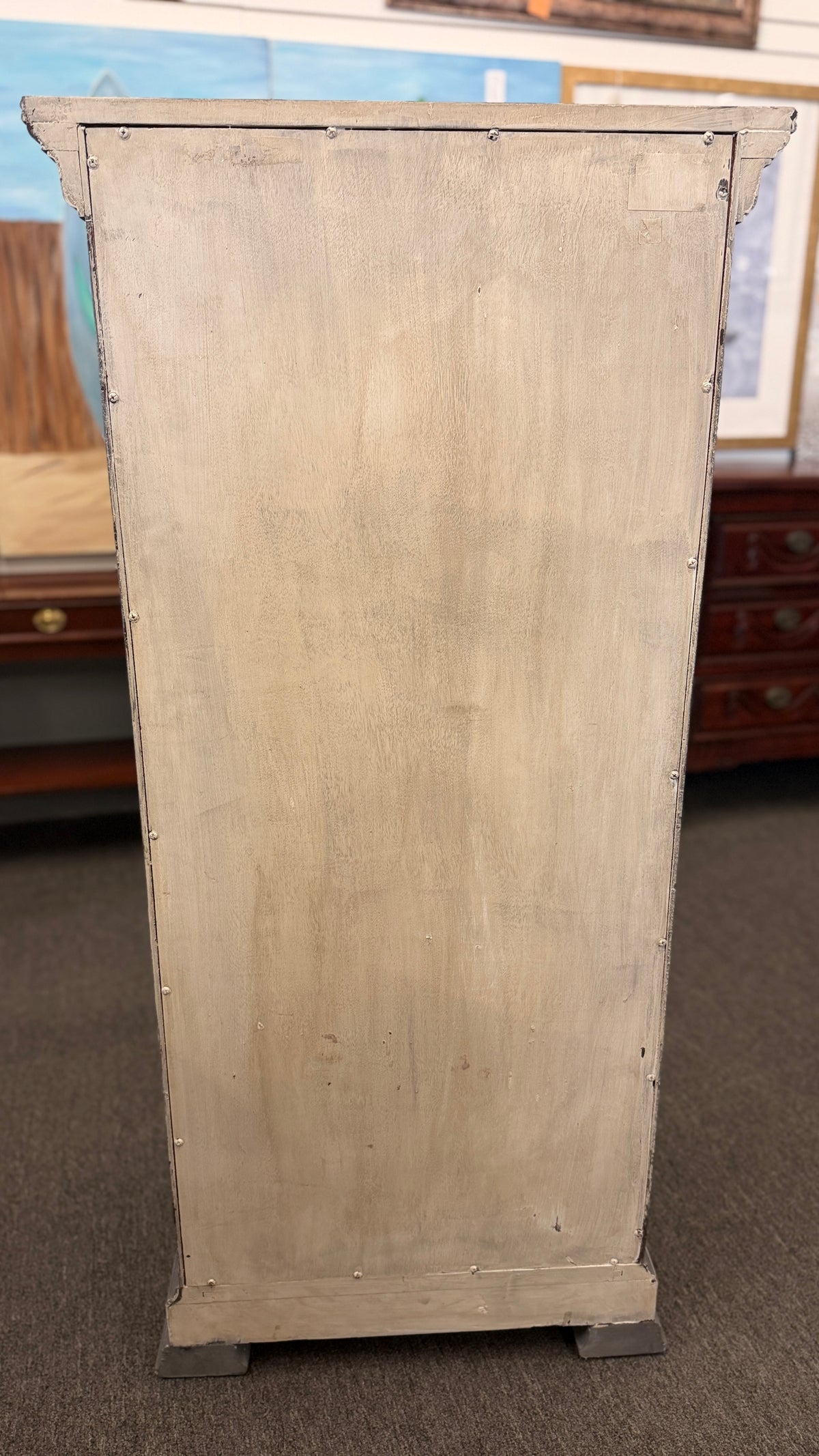 A tall slender Bassett jewelry armoire finished in distressed slate gray with white trim line detailing, six front drawers, and a flip-top lid with interior mirror in excellent condition.