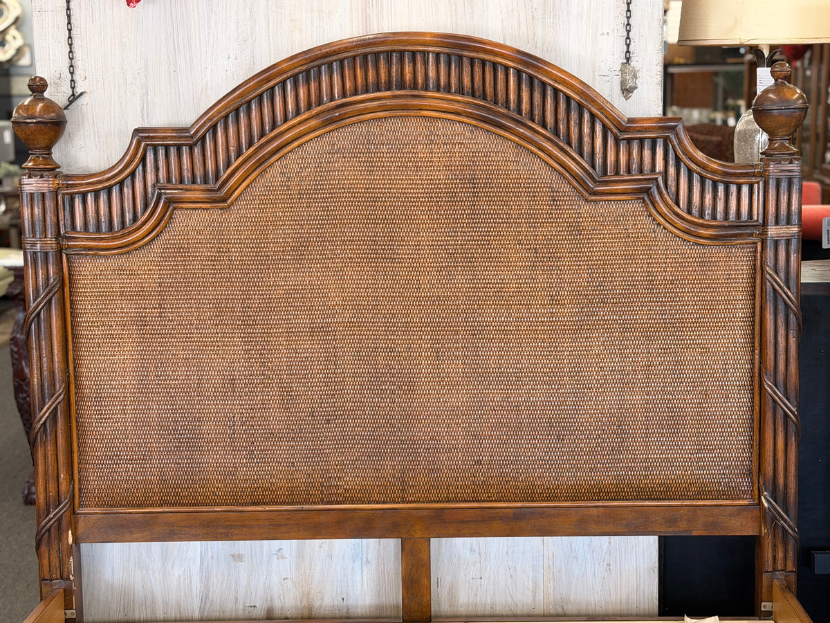 Carved wooden queen bed frame featuring arched woven rattan and cane panels on the headboard and footboard, accented with fluted posts and finials in excellent condition.