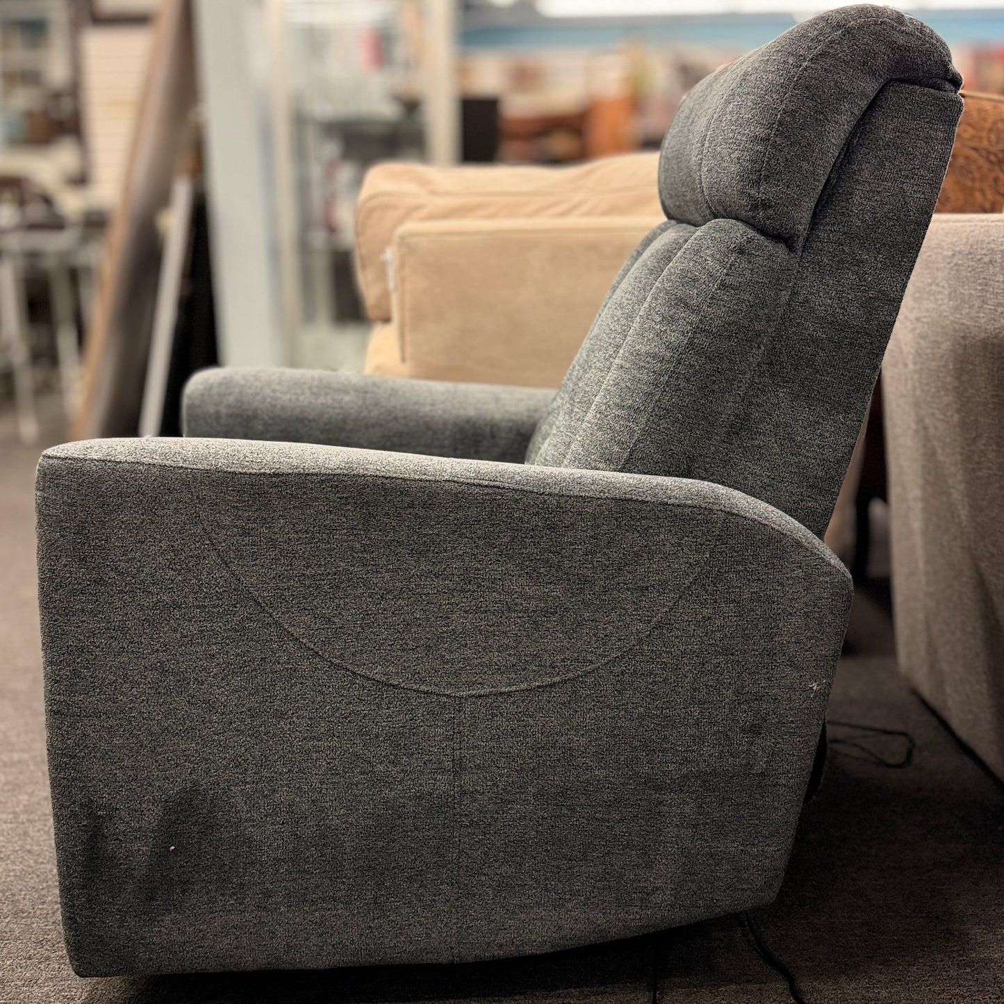 A contemporary high-back power recliner armchair upholstered in heather-gray woven fabric featuring segmented back cushioning and padded track arms in excellent condition.