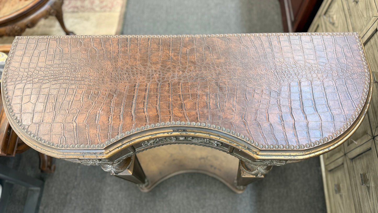 Distressed wood console table featuring ornate carved details, a center drawer, sculpted legs, and a gracefully curved lower stretcher.
