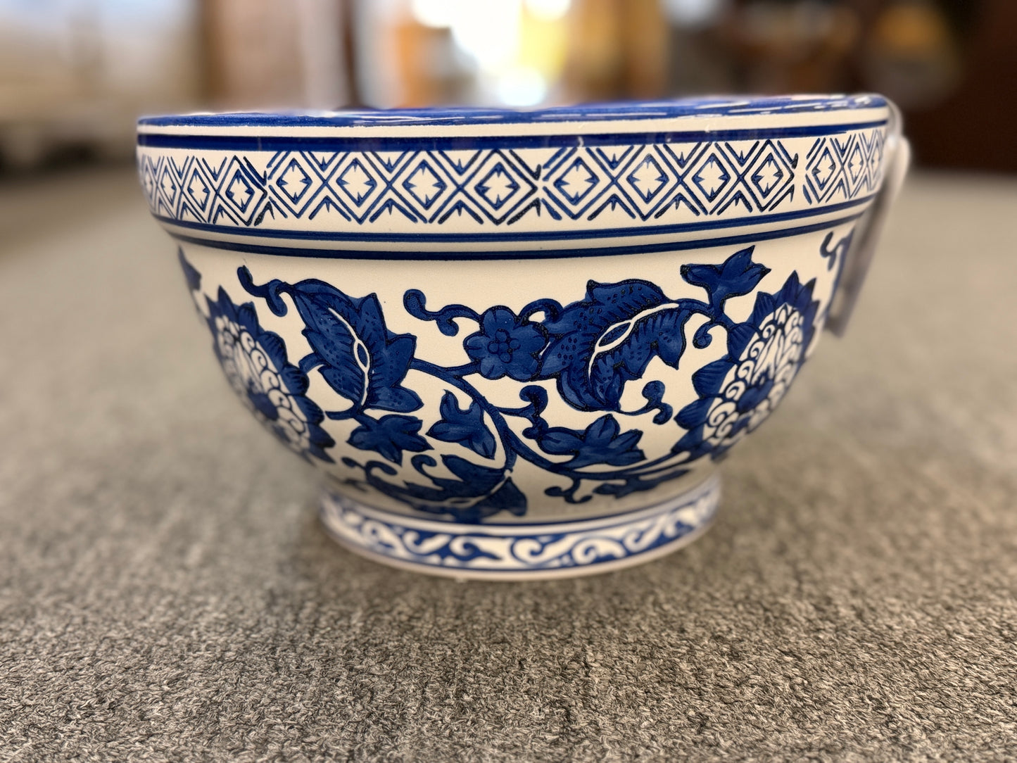 An elegant decorative oriental ceramic bowl resting on a flat surface in excellent condition.