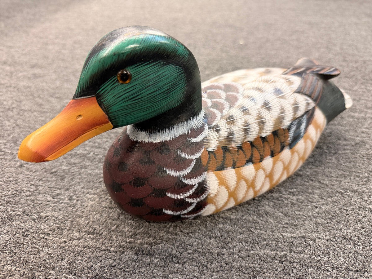 A hand-painted decorative wooden mallard duck decoy featuring detailed feather patterning and glass eyes in excellent condition.