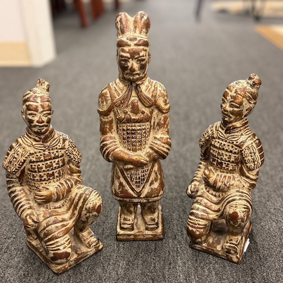 Set of three Terracotta Warrior replica figurines including one standing officer and two kneeling archers finished in a distressed antiqued gilt and terracotta-wash patina in excellent condition.