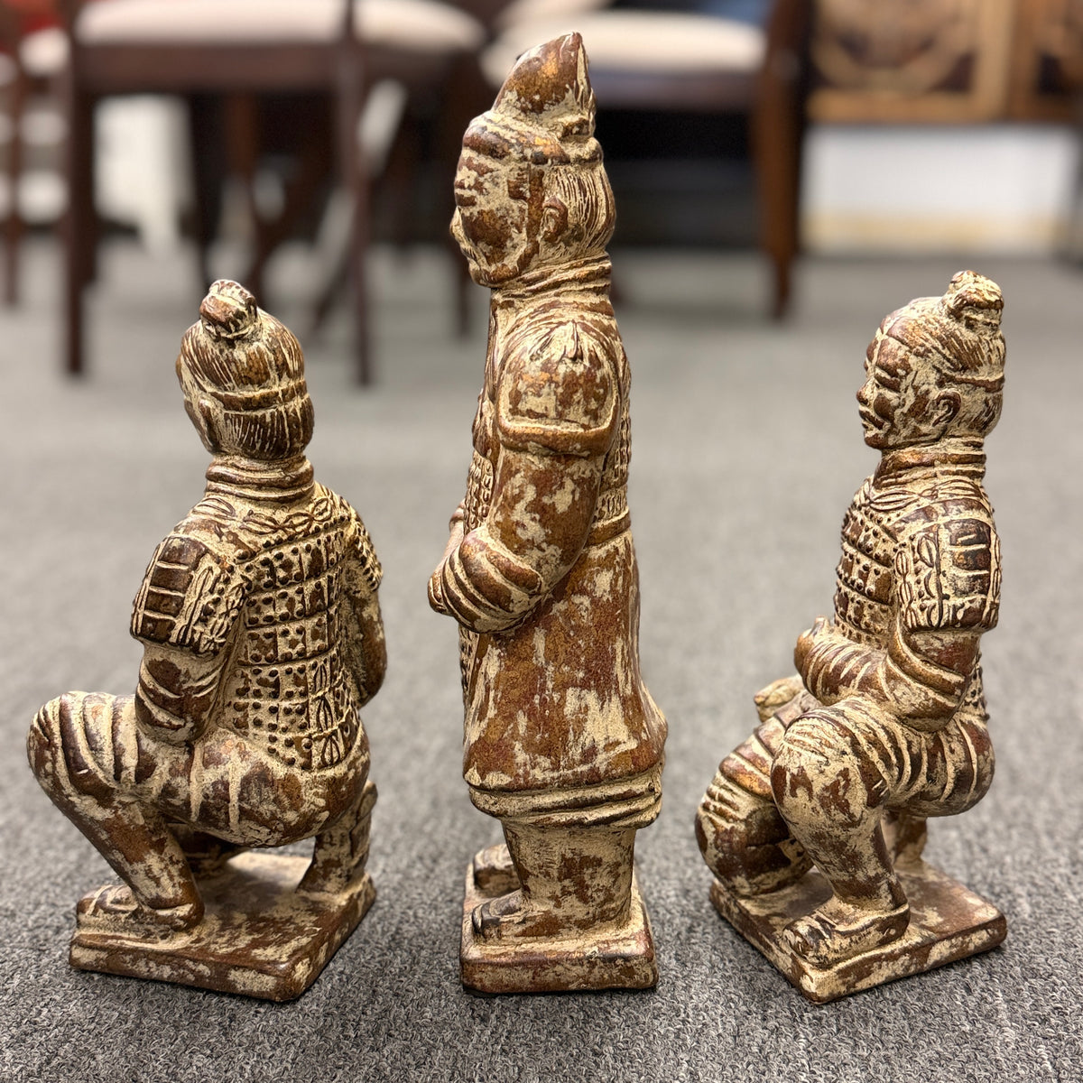 Set of three Terracotta Warrior replica figurines including one standing officer and two kneeling archers finished in a distressed antiqued gilt and terracotta-wash patina in excellent condition.