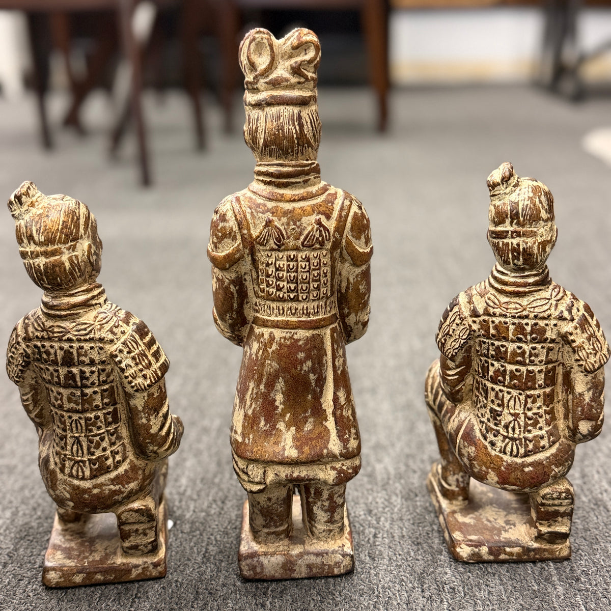 Set of three Terracotta Warrior replica figurines including one standing officer and two kneeling archers finished in a distressed antiqued gilt and terracotta-wash patina in excellent condition.