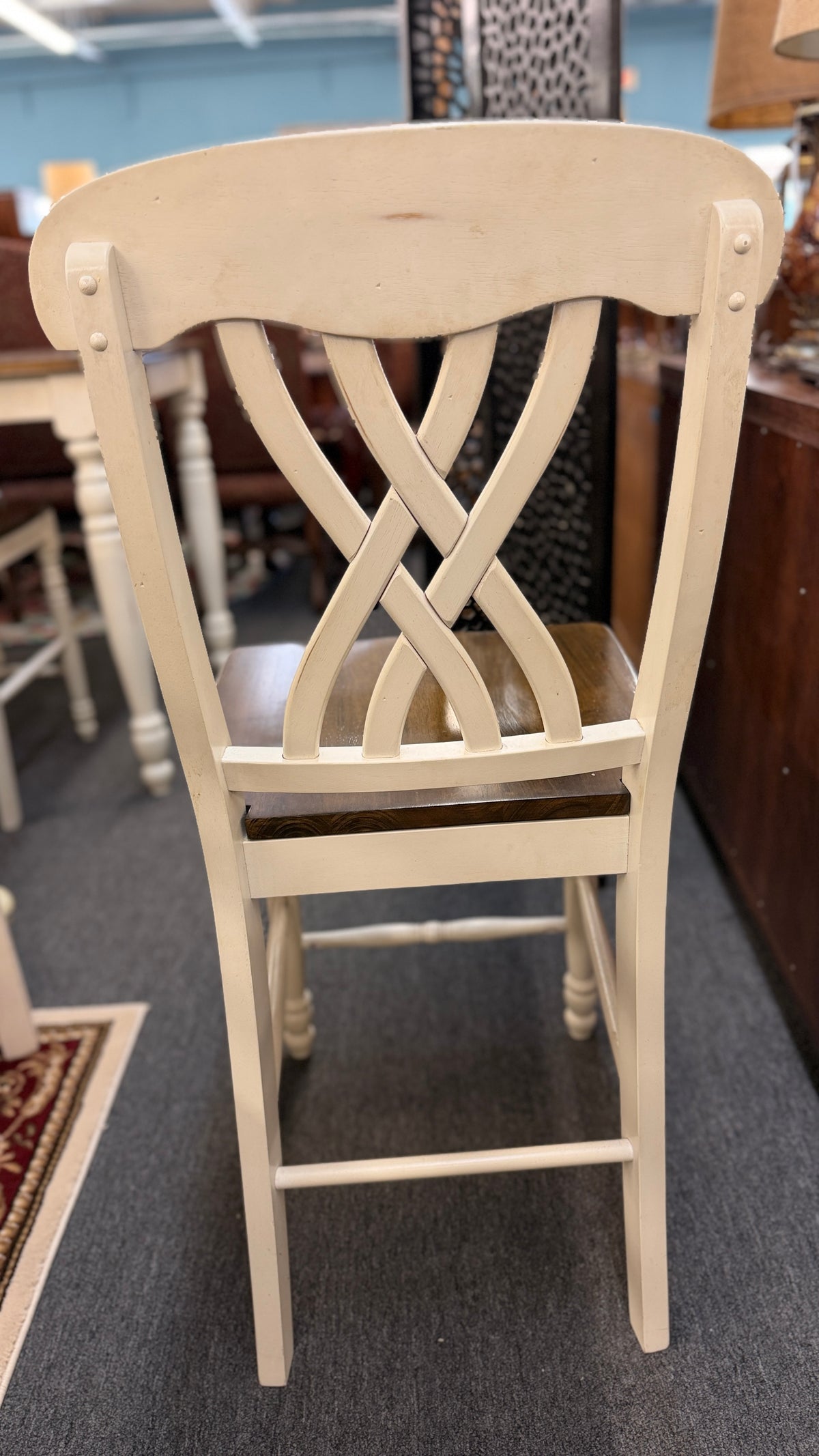 Two-tone counter-height dining set including a rectangular wood-top table with cream-painted turned legs and four matching open-back stools in excellent condition.