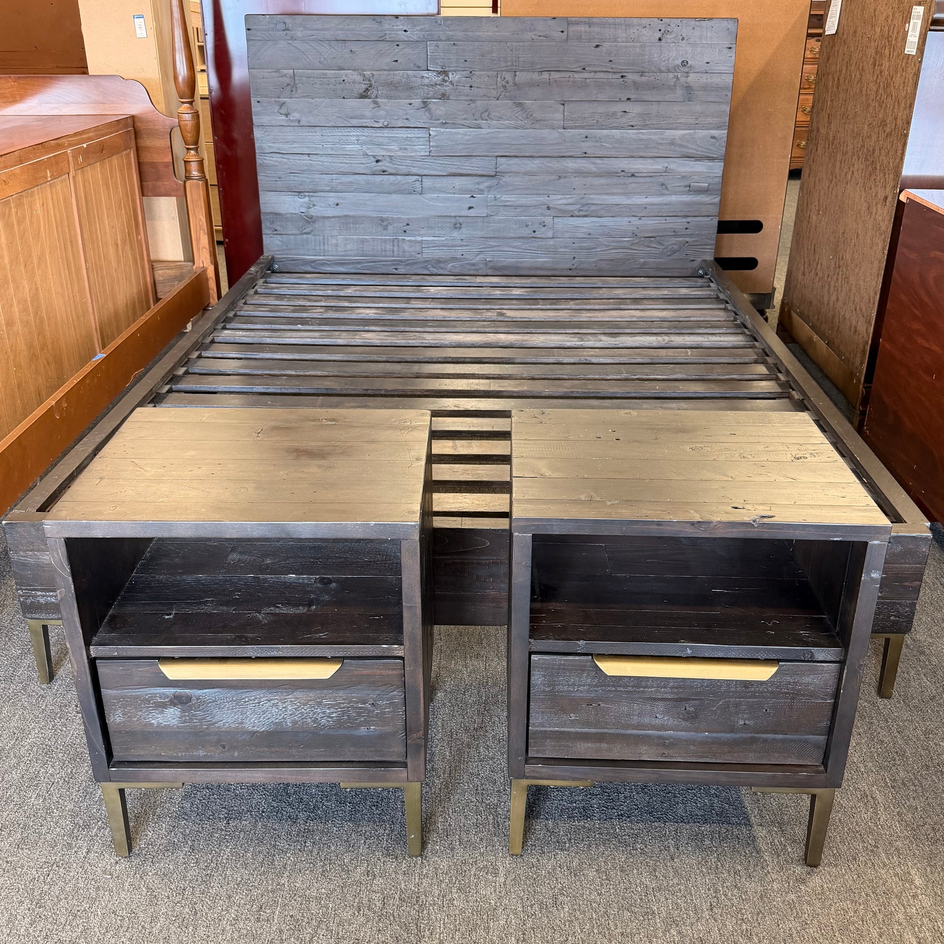 Wooden L-shaped desk with two drawers in a showroom setting