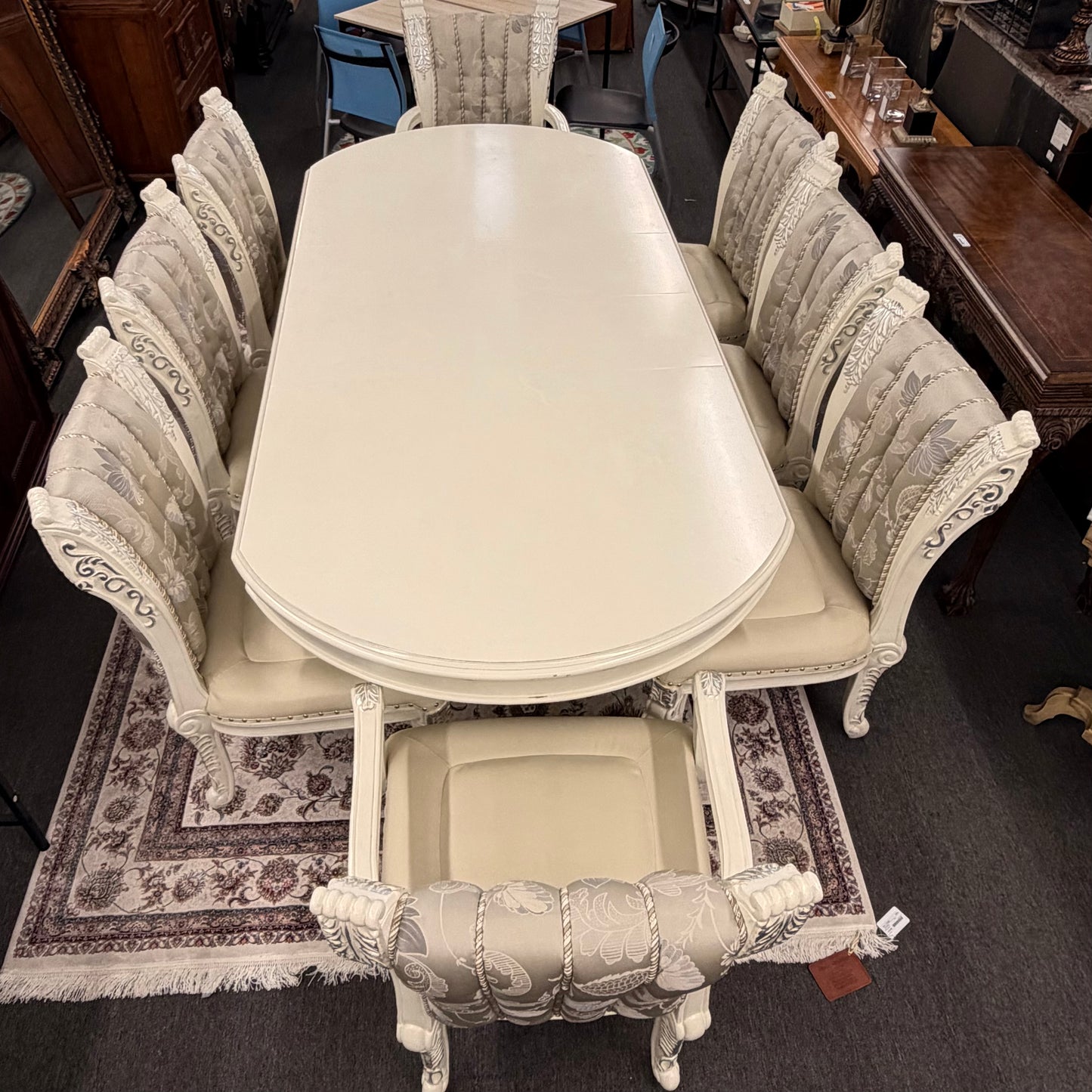 Dining table set with chairs in a showroom setting