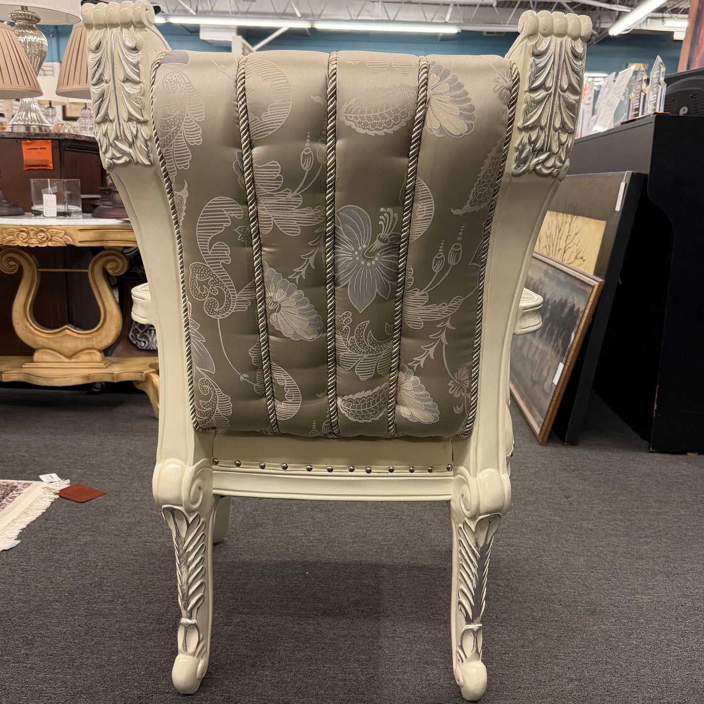 Decorative armchair with floral pattern in a store setting
