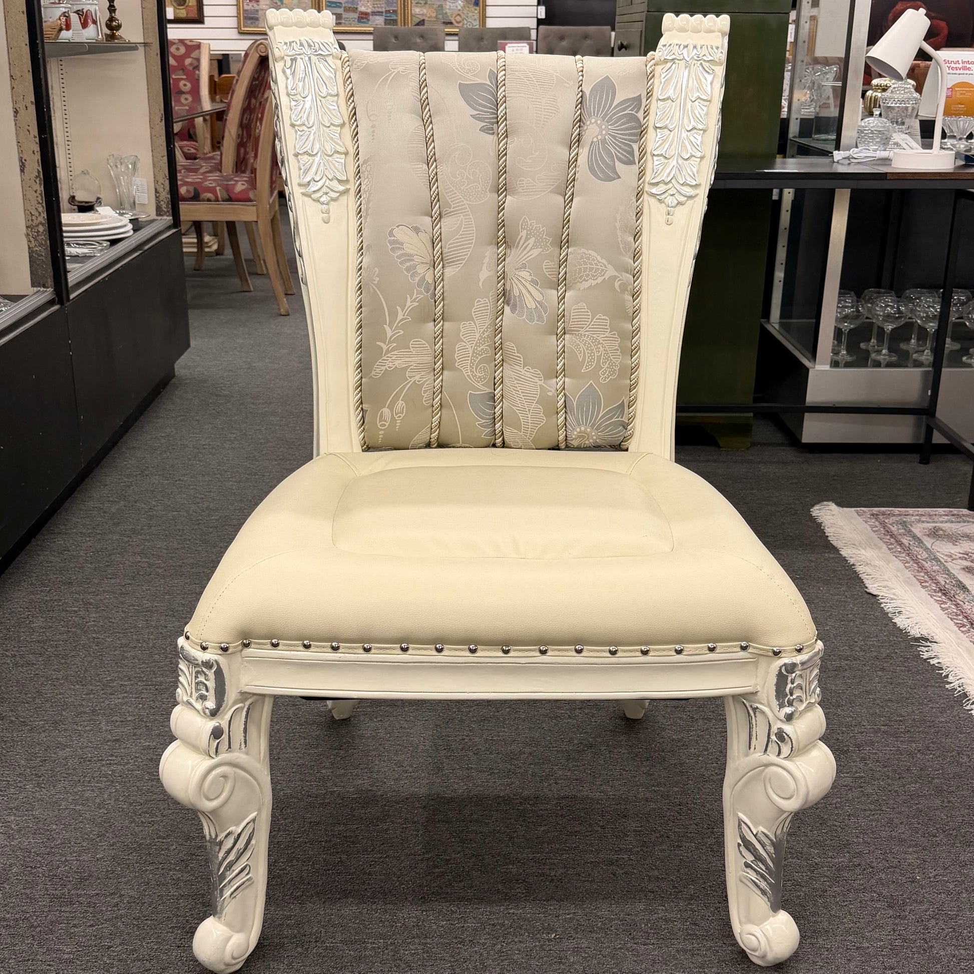Decorative chair with intricate designs in a showroom setting