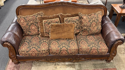 Decorative sofa with patterned cushions on a carpeted floor