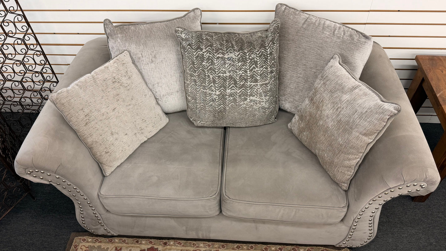 Gray sofa with decorative pillows in a room setting