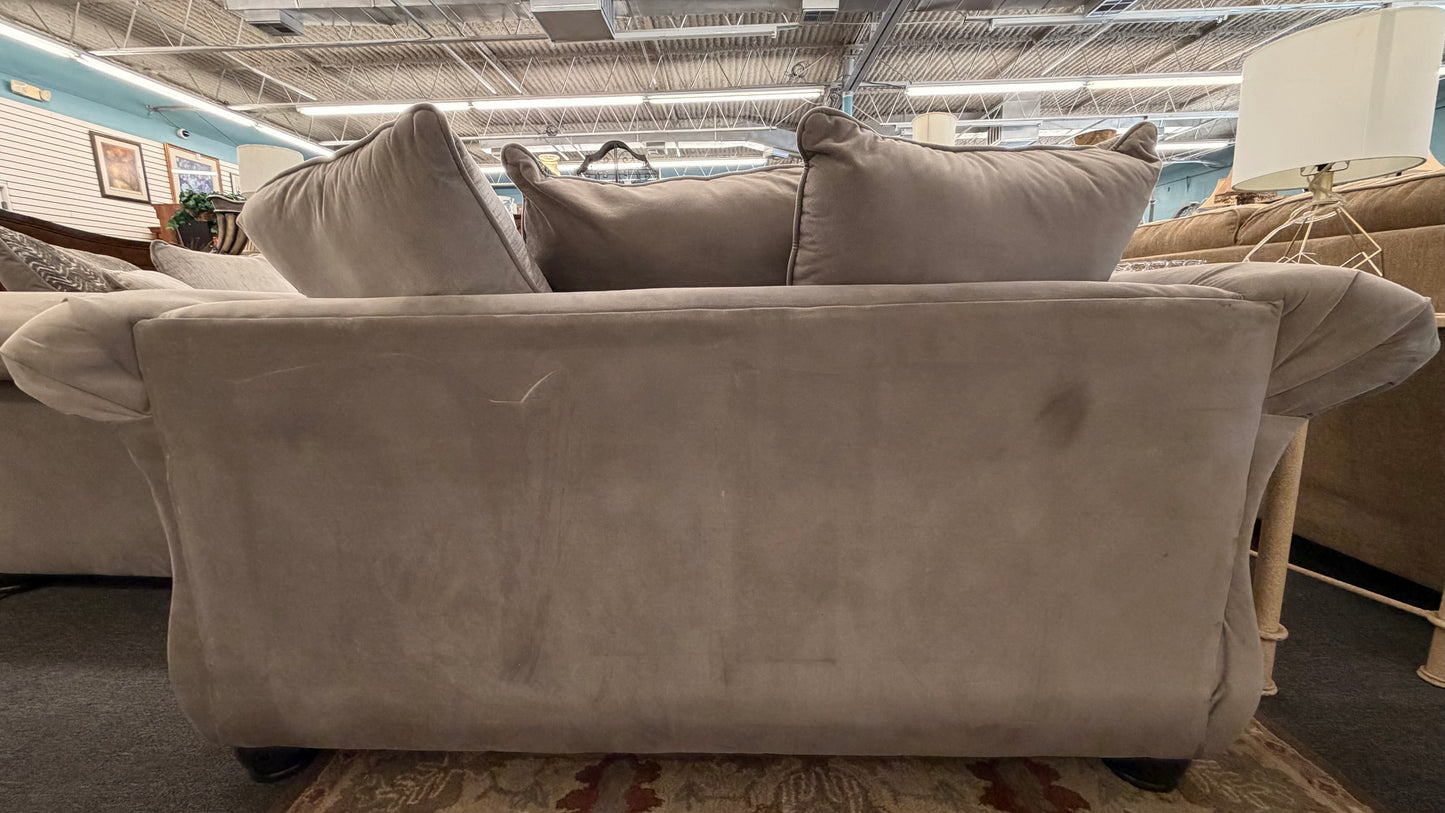 Gray sofa with cushions in a store setting