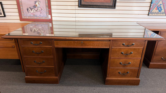 Wooden desk with multiple drawers in a store setting