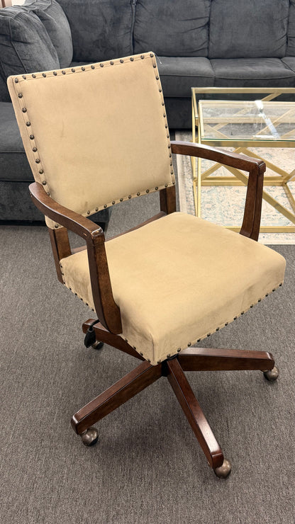Beige office chair with wooden frame on a gray carpeted floor.