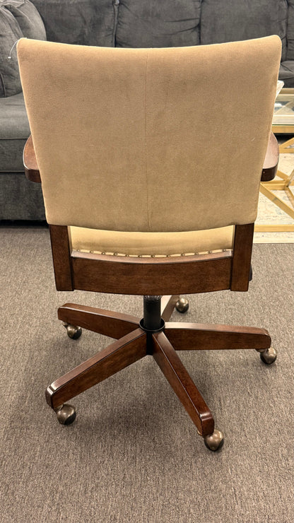 Beige office chair with wooden base on a gray carpeted floor.