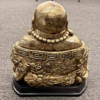 Bronze Buddha statue on a gray carpet