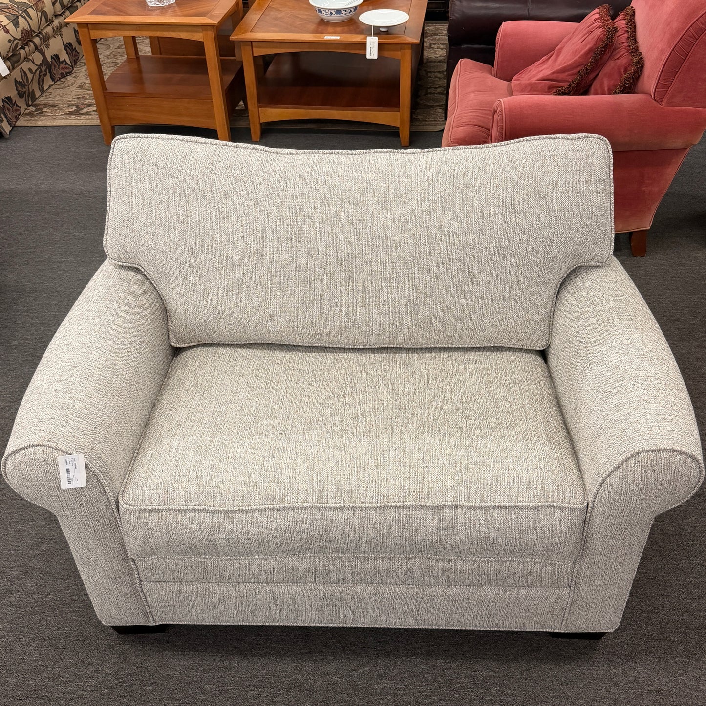 Gray armchair in a room with furniture and decor