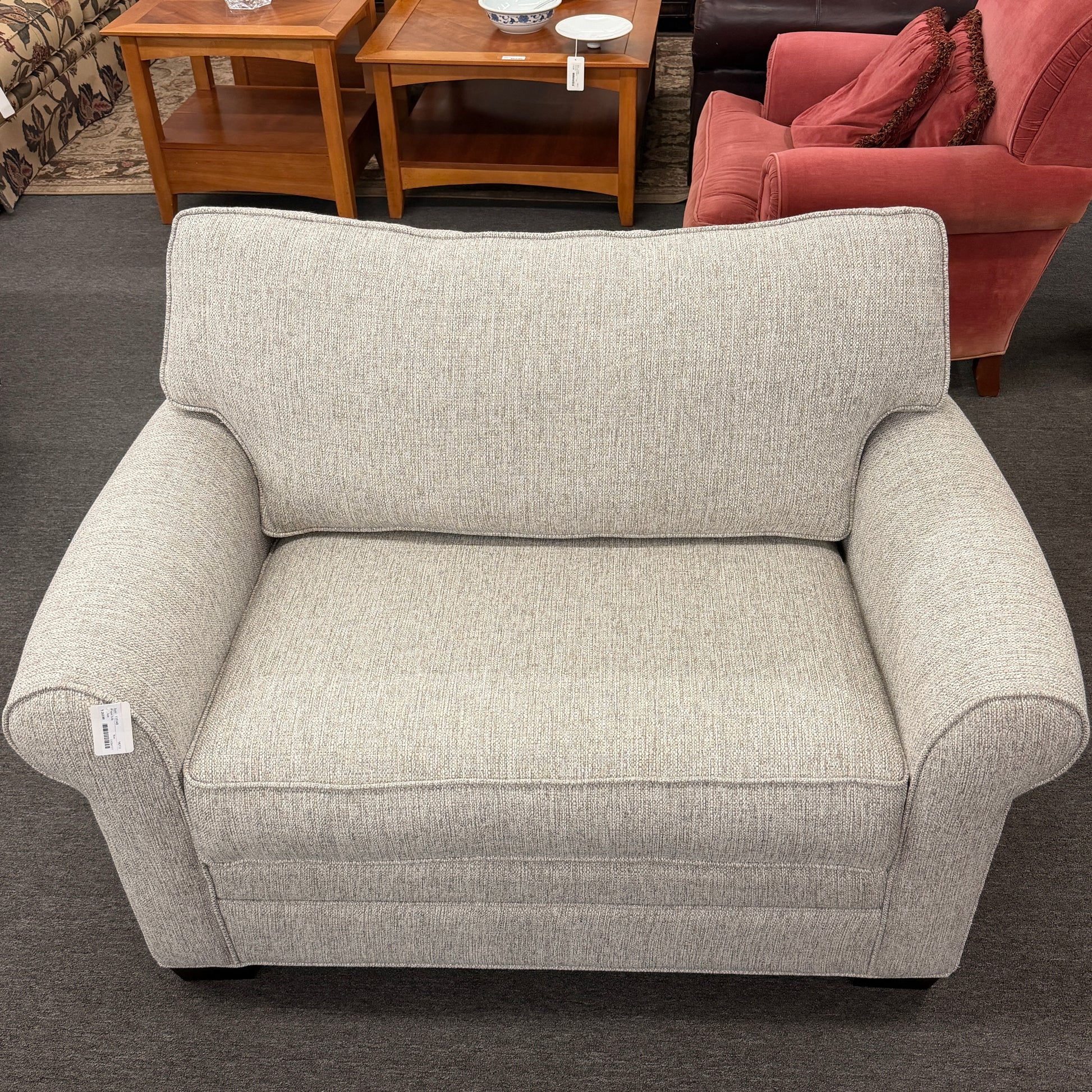 Gray armchair in a room with furniture and decor