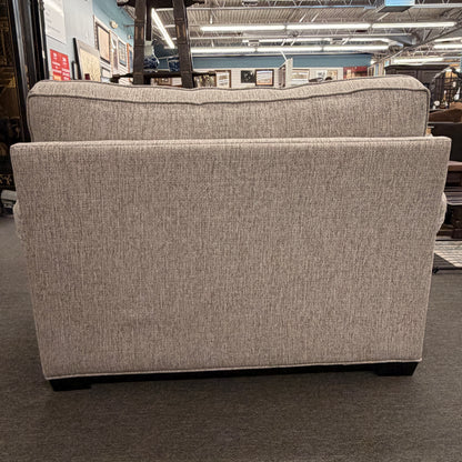 Gray upholstered chair in a store setting