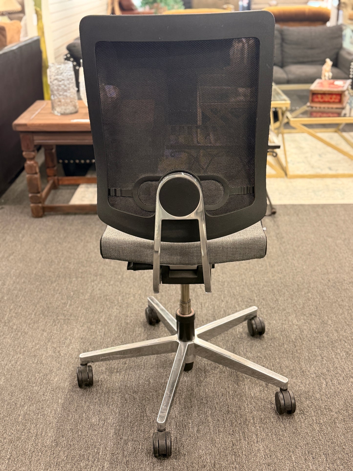 Gray office chair with mesh backrest in a room setting