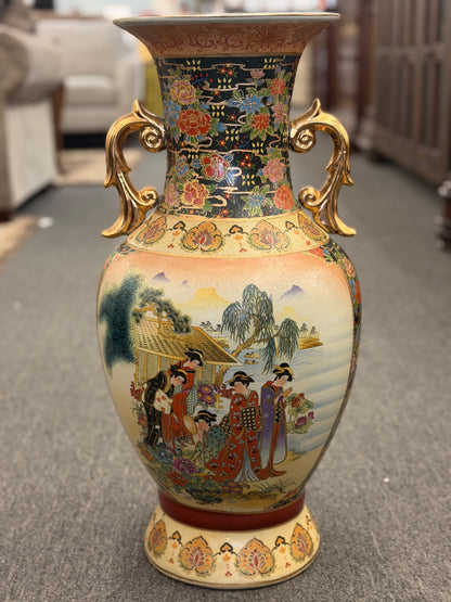 Decorative vase with intricate designs on a carpeted floor