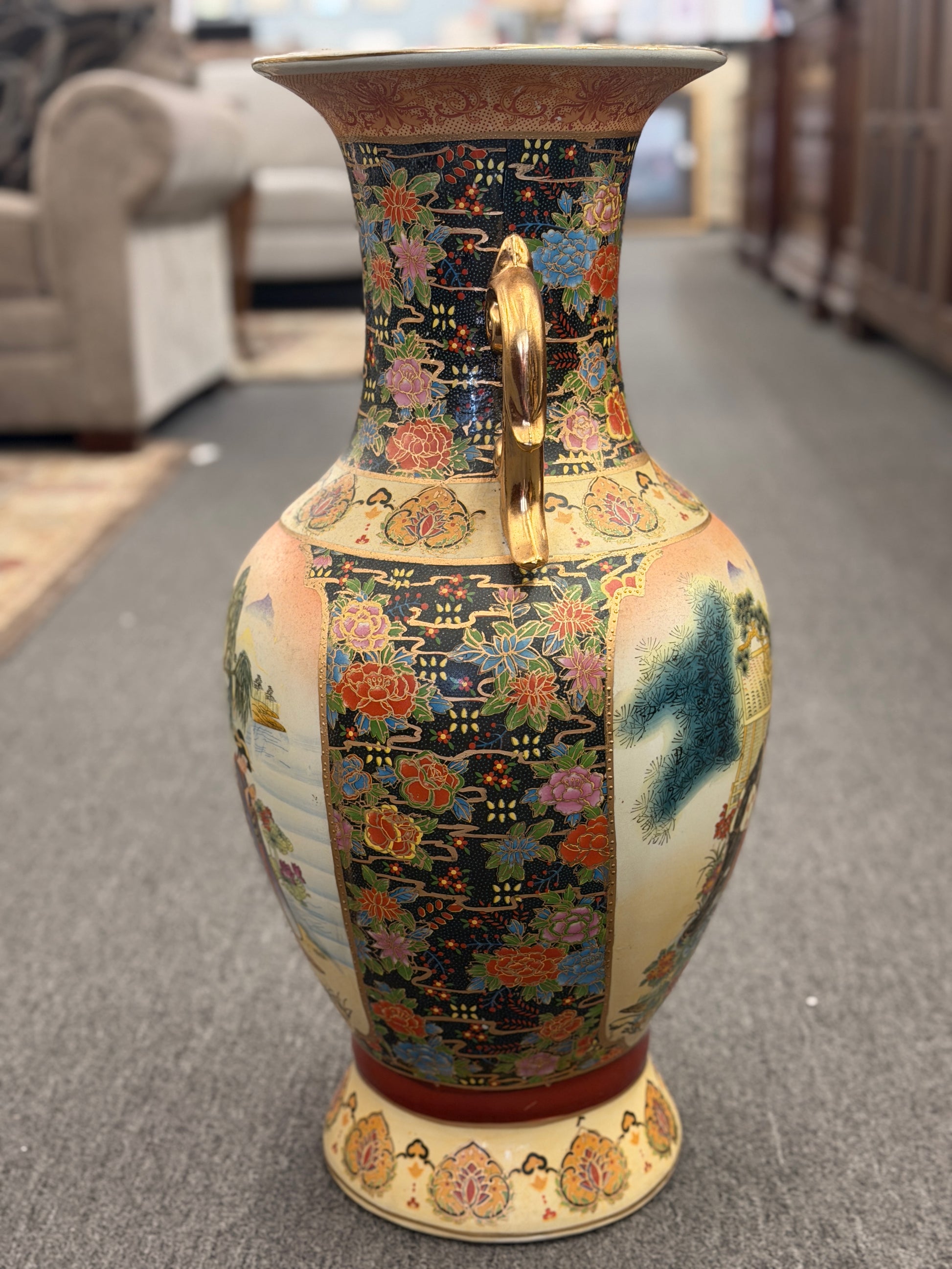 Decorative vase with intricate patterns on a carpeted floor