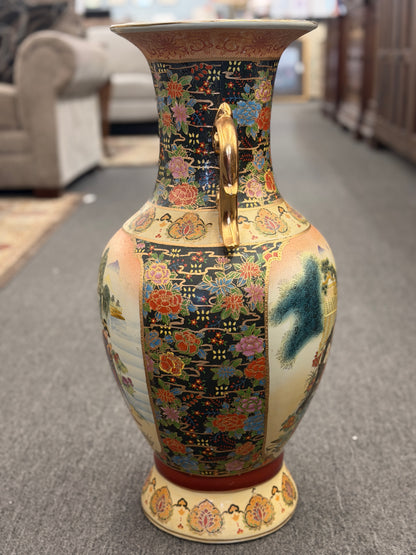 Decorative vase with intricate patterns on a carpeted floor