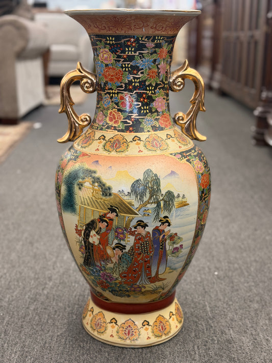 Decorative vase with intricate designs on a carpeted floor