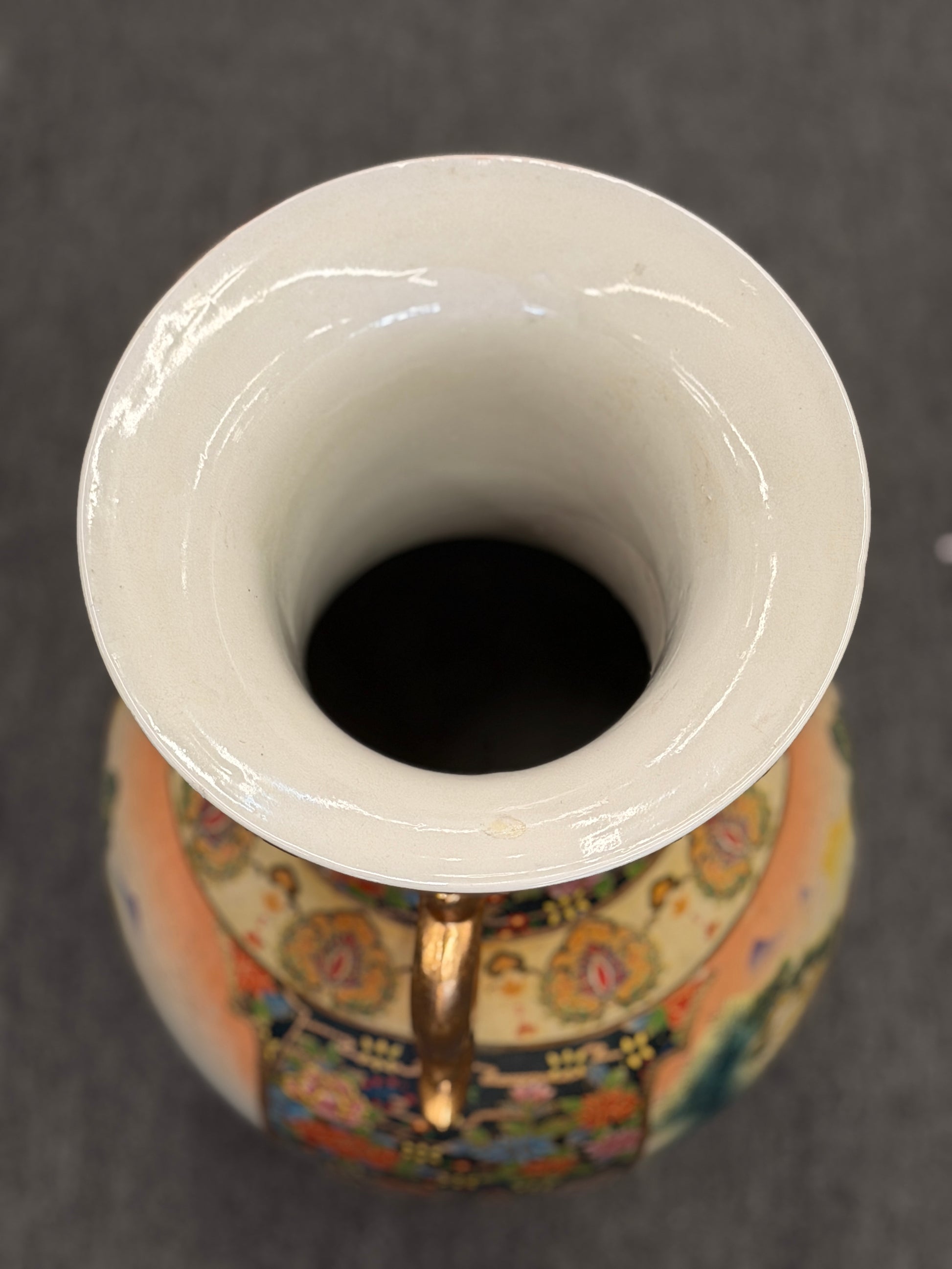 Close-up of a ceramic vase with colorful patterns and a white base.