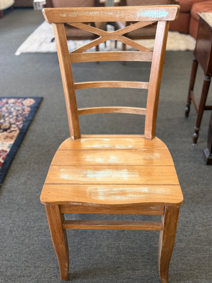 Wooden chair with slatted design on a carpeted floor