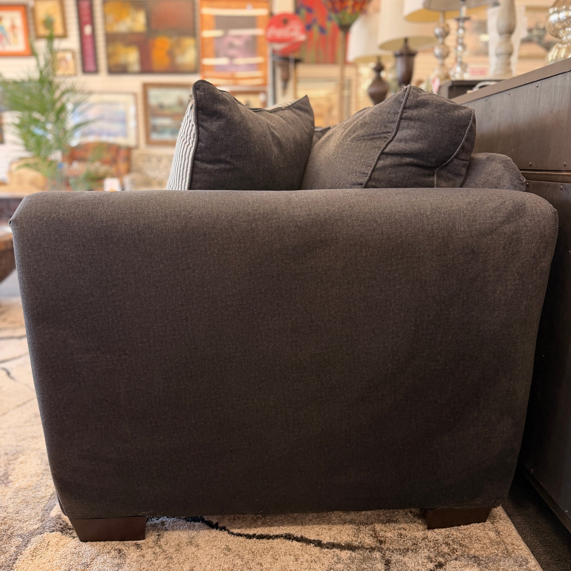 Gray sofa with cushions in a living room setting