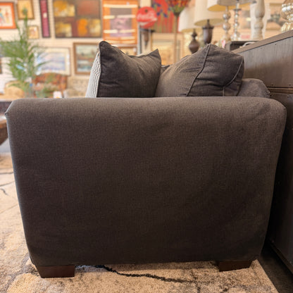 Gray sofa with cushions in a living room setting
