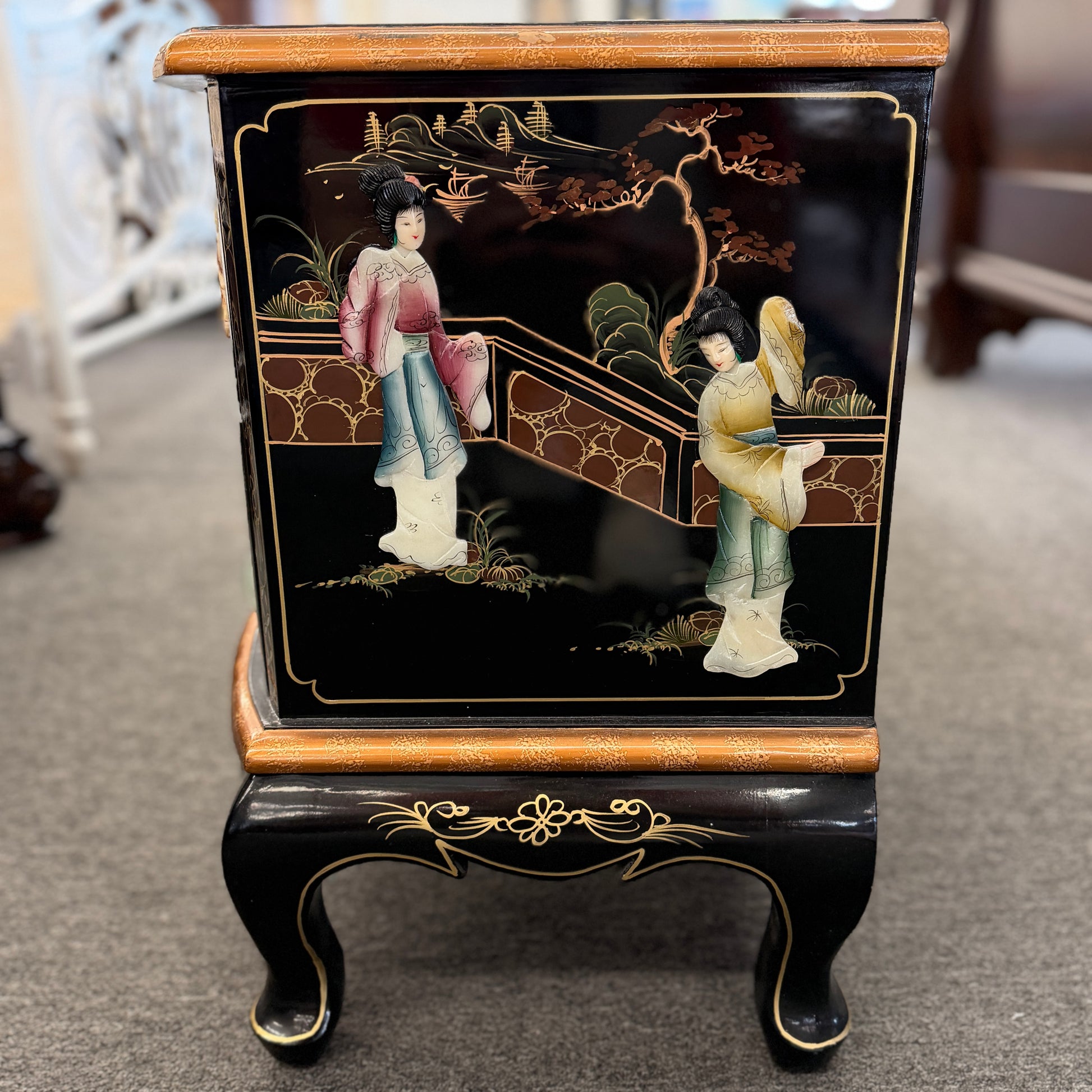Decorative cabinet with Chinese-style painting on a carpeted floor