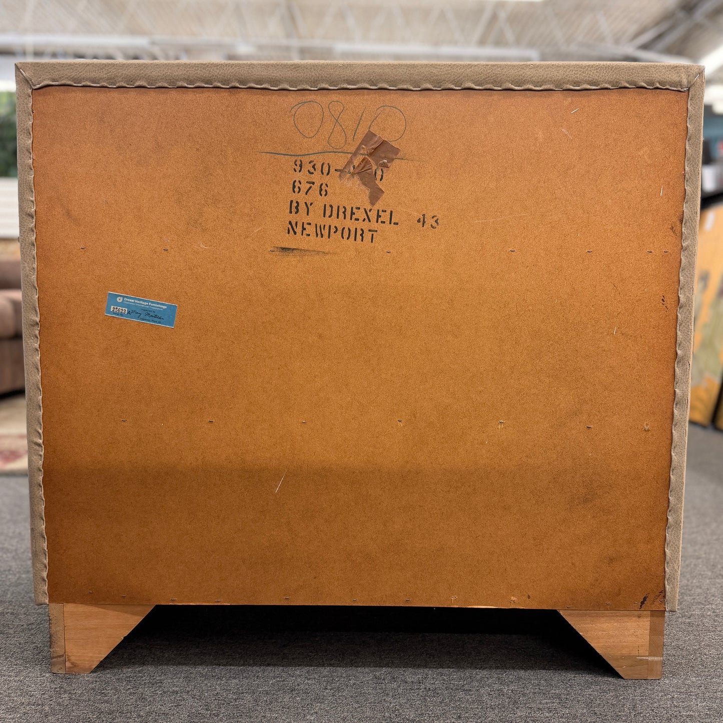 Cardboard box with Drexel Newport branding on a gray floor.