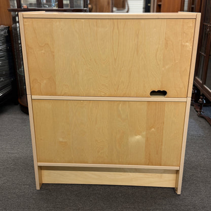 Light wood file cabinet with two drawers on a gray carpeted floor.