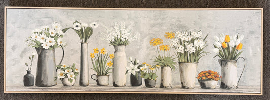 Decorative wall art with floral arrangements and watering cans on a textured background