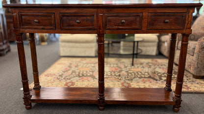 Wooden console table with drawers in a room setting