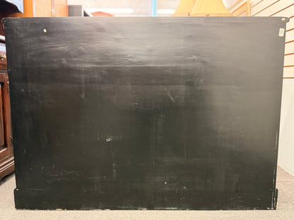Large blackboard with visible wear on a wooden surface