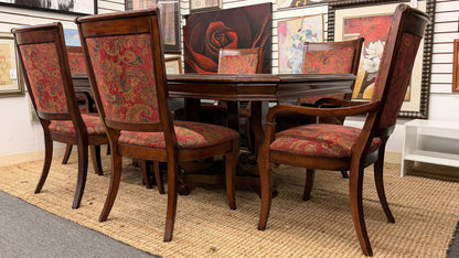Dining room set with wooden table and chairs in a showroom setting