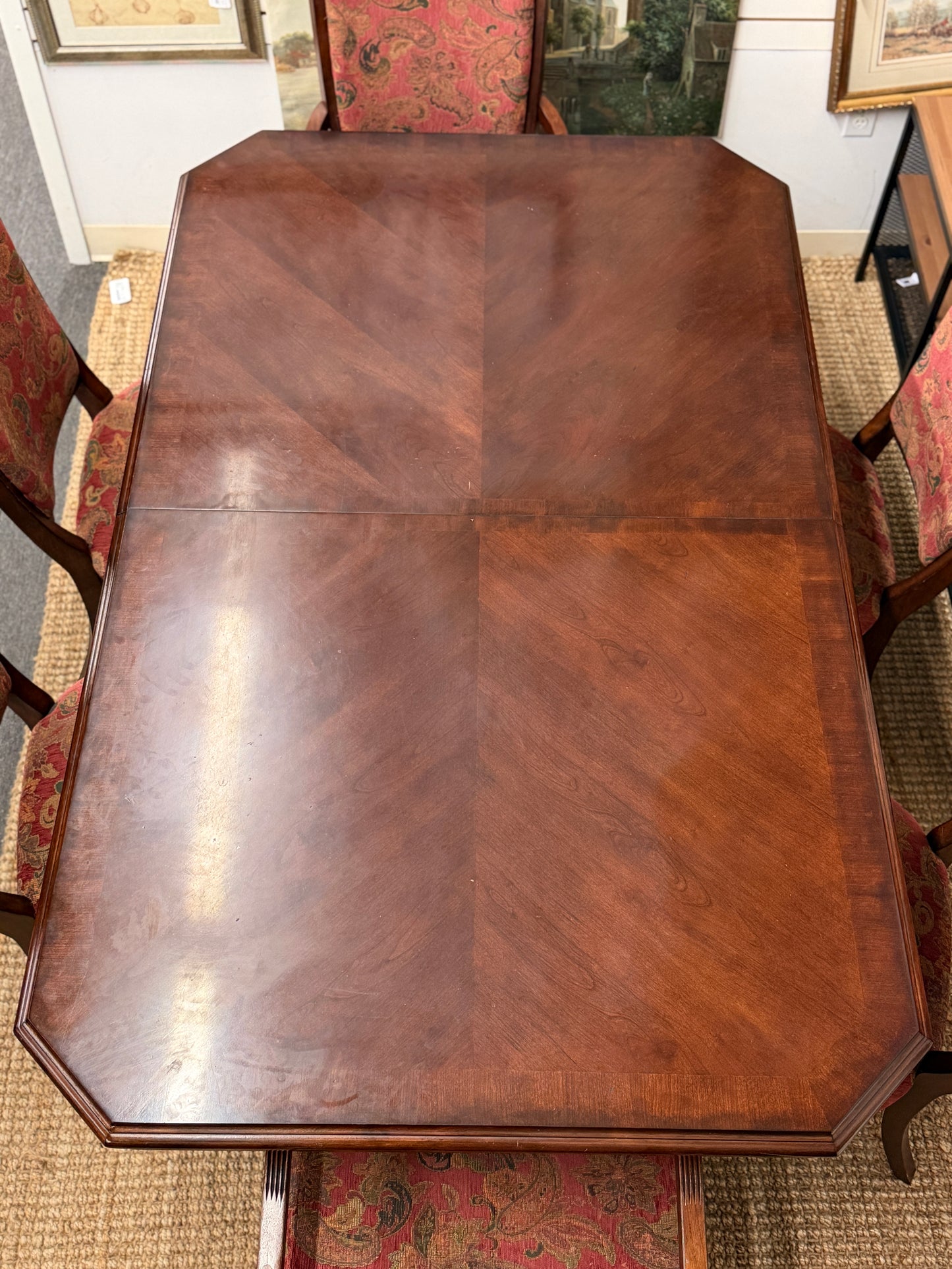Wooden dining table with chairs in a room setting